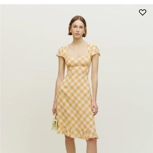 Rosi dress is a midi length dress with a cap sleeve and smocked back